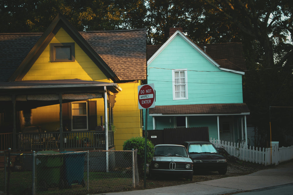 Two colorful houses with a 'Do Not Enter' sign in the foreground.