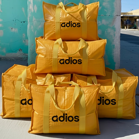 5 of yellow bags with 'adios' branding against a blue wall.